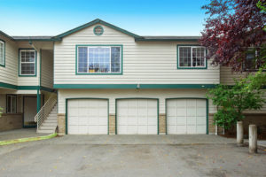 Front view of apartment building with three garage spaces. Northwest USA